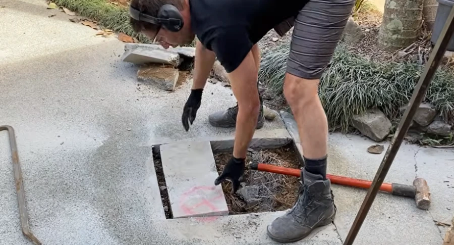 Excavated concrete slab exposing underground pipe during a slab leak repair in Pomona