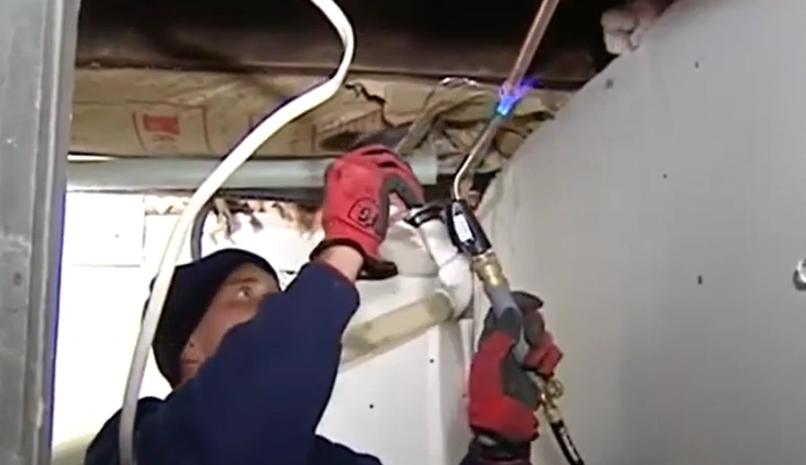 Repairing a pipe with a burner and a metal tube – burst pipe repair in San Dimas