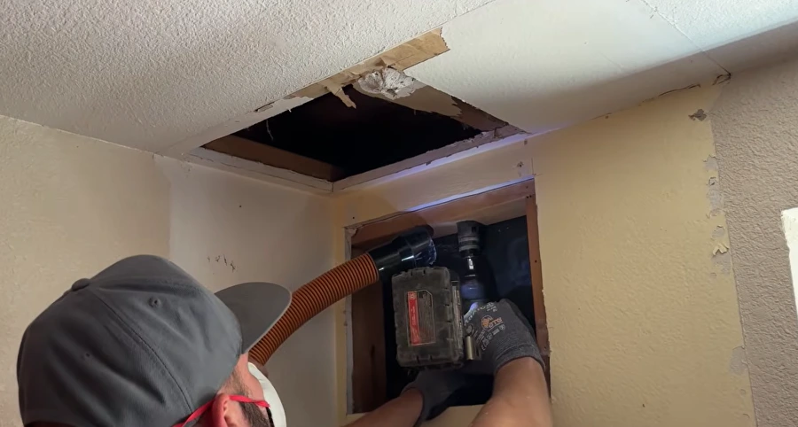 Injecting a machine into a wall to check for a water leak – burst pipe repair in Ontario